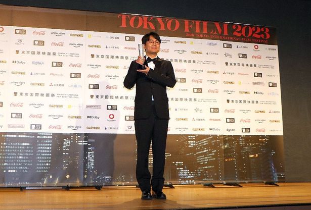 トロフィーを手にしたグー・シャオガン監督