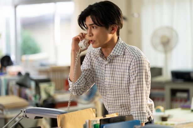 保護者からの電話対応で思わず立ち上がる市川