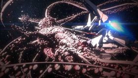 嫌悪感を抱くようなビジュアルの奇居子と戦う衛人